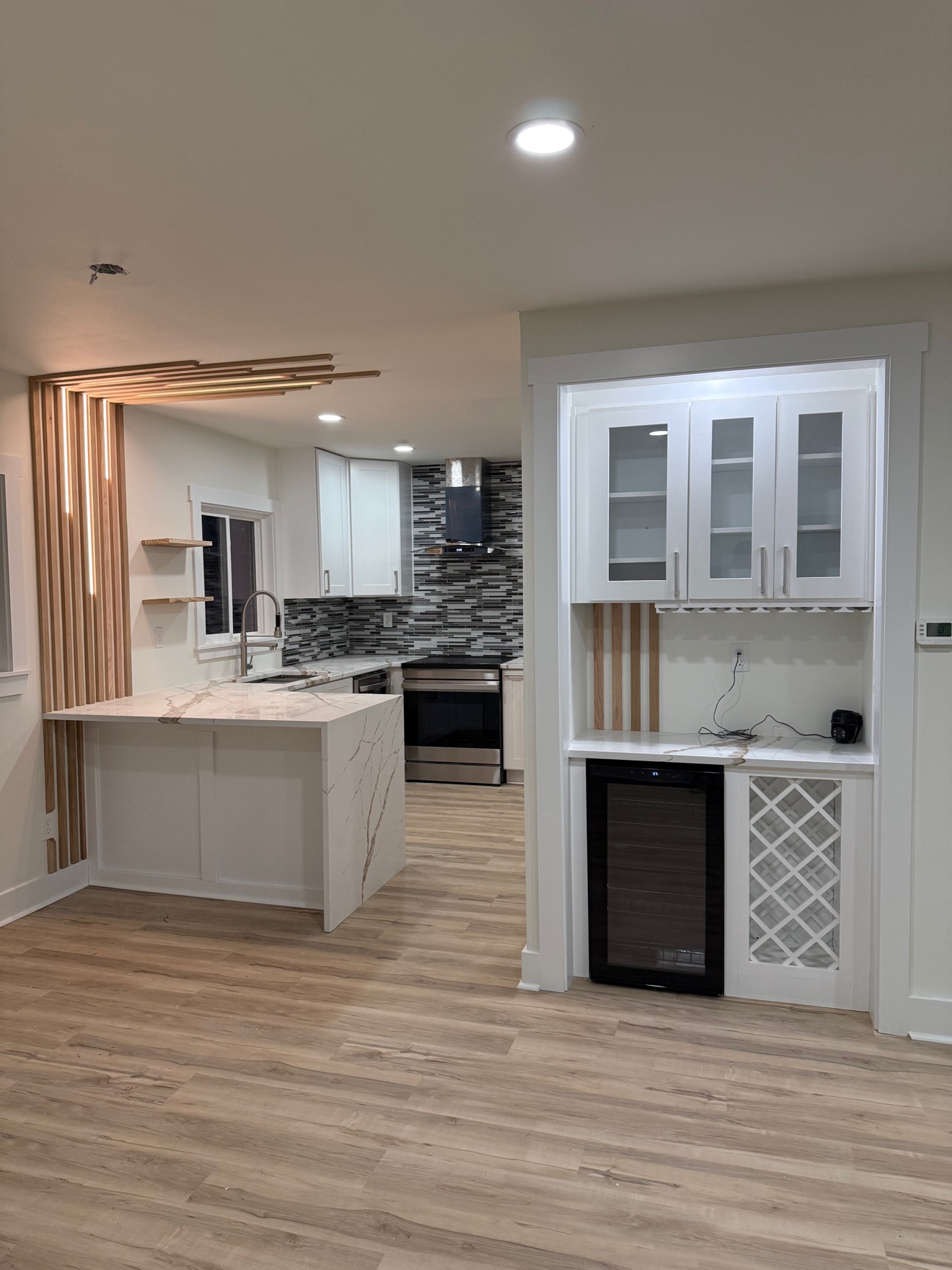 Modern kitchen with white cabinets and a built-in wine bar